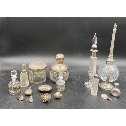 781 - A collection of silver and glass items to include four perfume bottles, perfume pendant, perfume bot... 