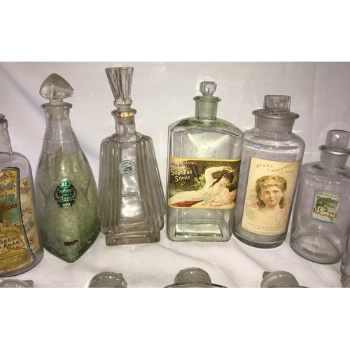 412 - A collection of vintage glass bottles, some old medicine bottles, with labels to include, Humphreys ... 