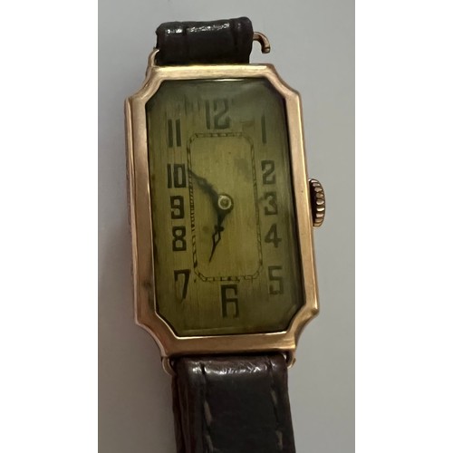 955 - A nine carat gold cased ladies wristwatch with brown leather strap.   Watch face 2.5cm x 1.5cm. Tota... 