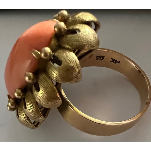 590 - A 14 carat gold cocktail ring, peach coloured stone set in flower head setting. 9.6gm total. Size N.