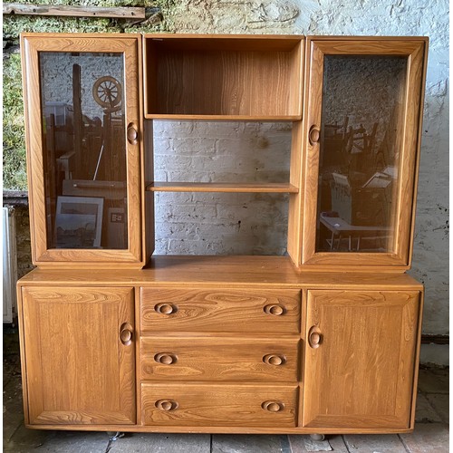 104 - Ercol sideboard with a pair of Windsor light glazed cupboards to the top with shelves joining the tw... 