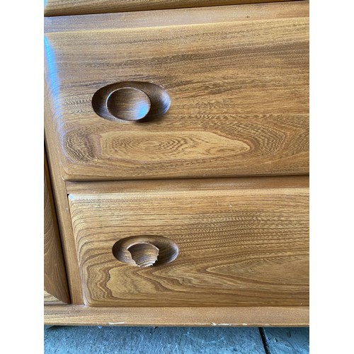 104 - Ercol sideboard with a pair of Windsor light glazed cupboards to the top with shelves joining the tw... 