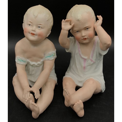 241 - Two Gebruder Heubach piano dolls modelled both seated, one with arms raised 17cm, the other 16cm. Bo... 