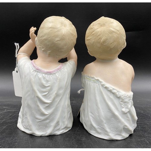 241 - Two Gebruder Heubach piano dolls modelled both seated, one with arms raised 17cm, the other 16cm. Bo... 