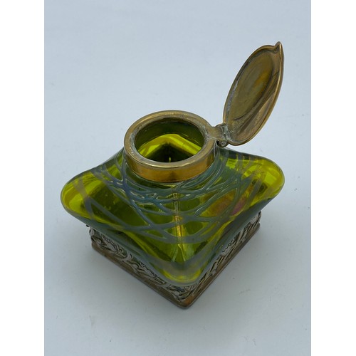 417 - An Art Nouveau inkwell with green iridescent glass and brass hinged cover stamped DRGM 168180 GER103... 