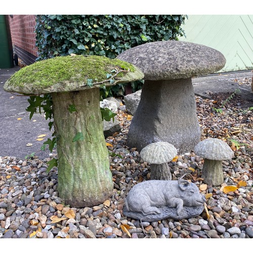 226 - A collection of reconstituted stone mushrooms and piglet, tallest mushroom 41cm.