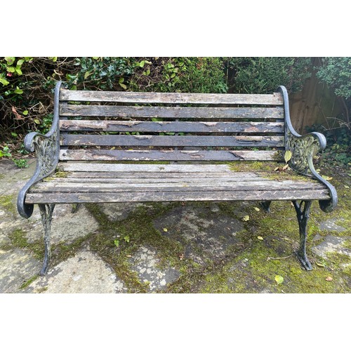 228 - A wooden and cast iron bench. 126 w x 78cm h.