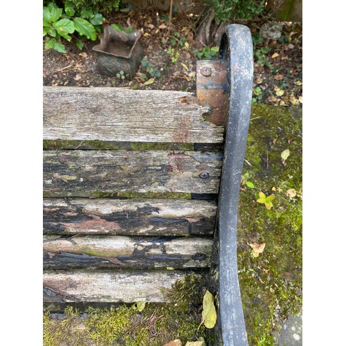 228 - A wooden and cast iron bench. 126 w x 78cm h.