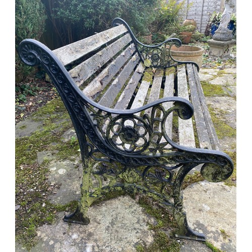 228 - A wooden and cast iron bench. 126 w x 78cm h.