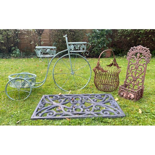 219 - A collection of metal outdoor items to include bicycle plant stand, cast iron door mat, cast iron wa... 