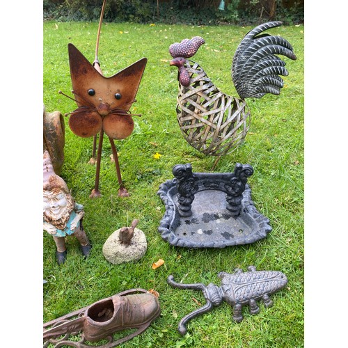 220 - A miscellany of garden ornaments to include cast iron planter, bird bath, boot scraper, cast iron gn... 