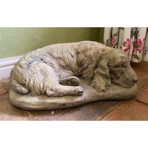 221 - A reconstituted setter stone dog. 45 w x 29 x 18cm h approx.