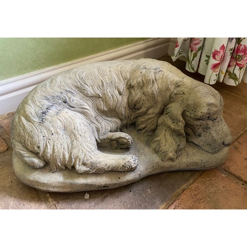 221 - A reconstituted setter stone dog. 45 w x 29 x 18cm h approx.