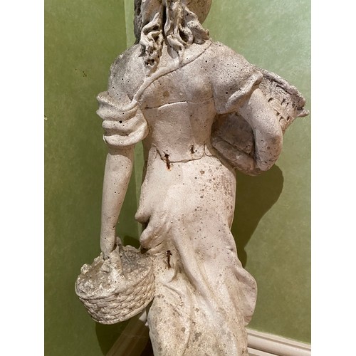 222 - A reconstituted stone figure of a female carrying baskets. 70cm h.