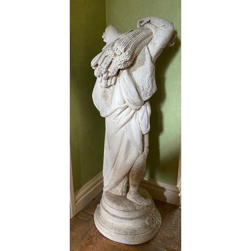 223 - A reconstituted stone figure of a man carrying sheaves of corn. 79cm h.