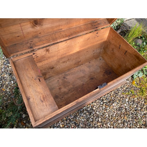 124 - A pine blanket box with interior candle box. Domed top and metal handles. 98.5 w x 55 d x 59cm h.