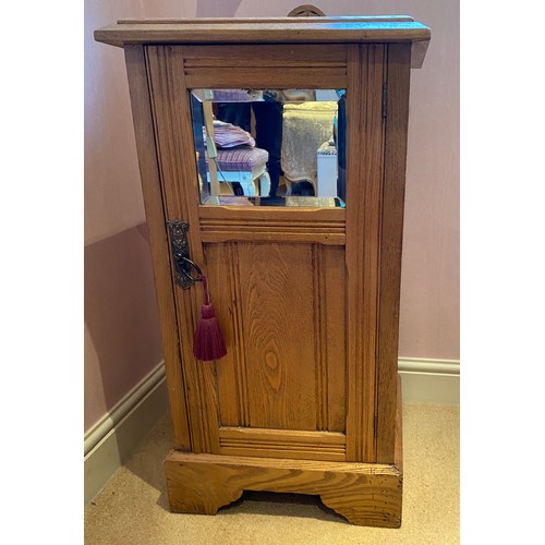 125 - A pine pot cupboard, bevel edged mirror to door front with shelf to interior. 75 h x 41 w x 33cm.