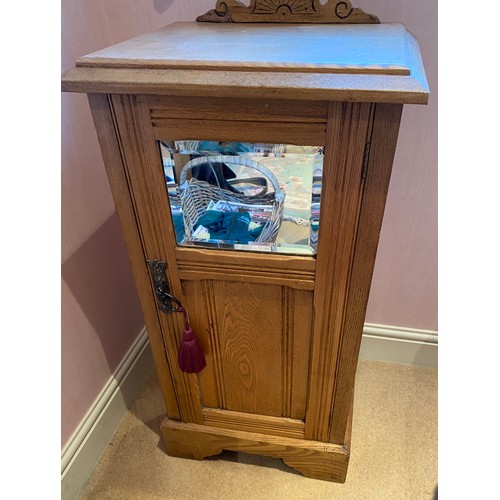 125 - A pine pot cupboard, bevel edged mirror to door front with shelf to interior. 75 h x 41 w x 33cm.