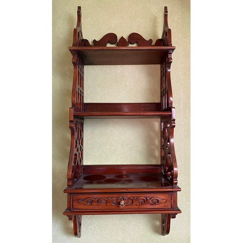 127 - A decorative wall shelf with drawer to base and fretted sides. 84 h x 34 w x 19cm d.