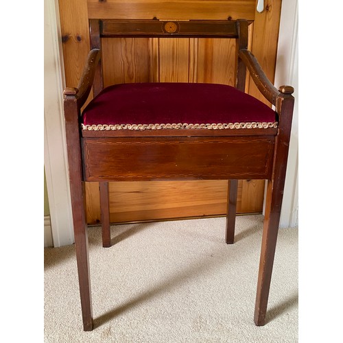 130 - An Edwardian mahogany inlaid piano stool with arms and lift up seat.