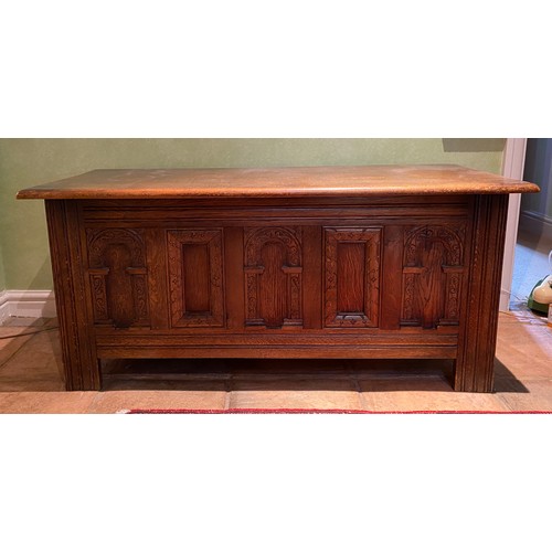 135 - A carved oak coffer with carvings to front and sides. 113 w x 51 h x 46cm d.