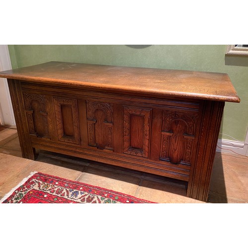 135 - A carved oak coffer with carvings to front and sides. 113 w x 51 h x 46cm d.