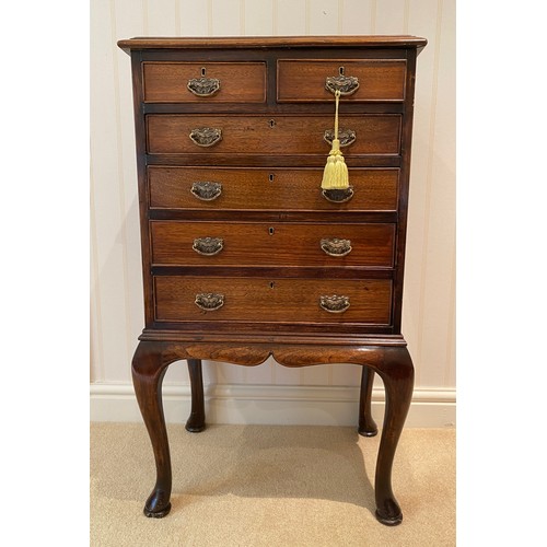 136 - A burr walnut chest of drawers on cabriole legs, 2 short over 4 long.