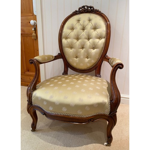 138 - A 19thC walnut button backed upholstered ladies chair on cabriole legs and ribbon carving to top.