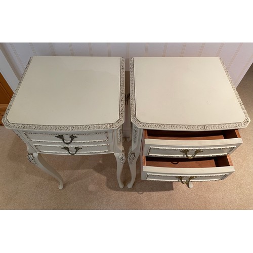 140 - A pair of cream and gilt bedside tables with two drawers to front raised on cabriole legs. 68cm h x ... 