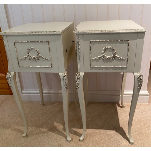 140 - A pair of cream and gilt bedside tables with two drawers to front raised on cabriole legs. 68cm h x ... 