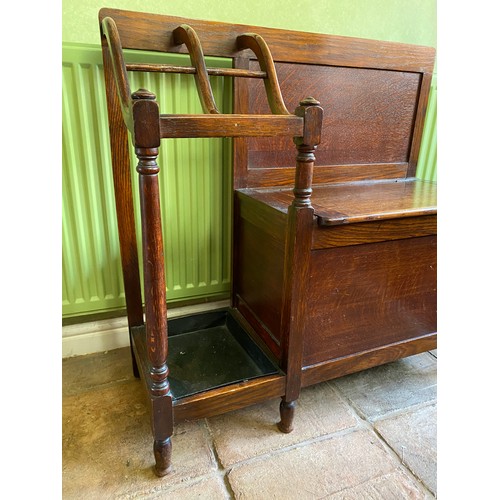 145 - An oak hall seat with umbrella stand and lift out drip tray. 81 w x 30 x 79cm h.