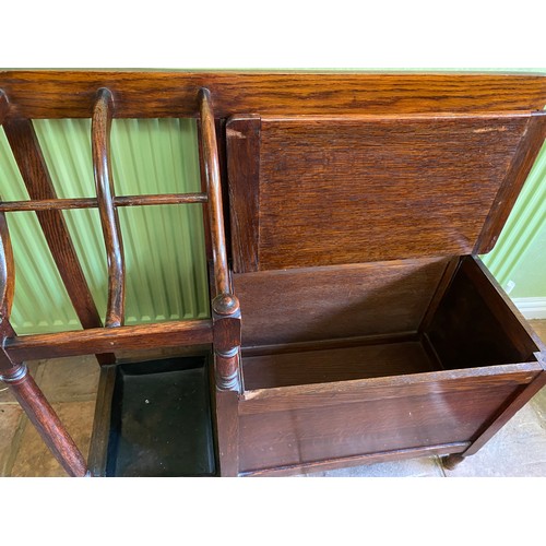 145 - An oak hall seat with umbrella stand and lift out drip tray. 81 w x 30 x 79cm h.