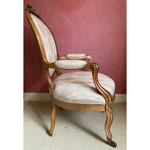 148 - A 19thC upholstered open armchair with gilt mounts and cabriole legs.