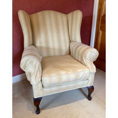 156 - A good quality upholstered wing armchair on cabriole legs.