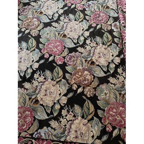 1221 - A 20thC tapestry rug, black background with pink and pastel roses. 176 x 226cm.