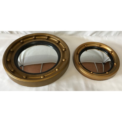 1132 - Two Convex wall mirrors with black inner trim largest 37.5cm diameter, smallest 27cm diameter.