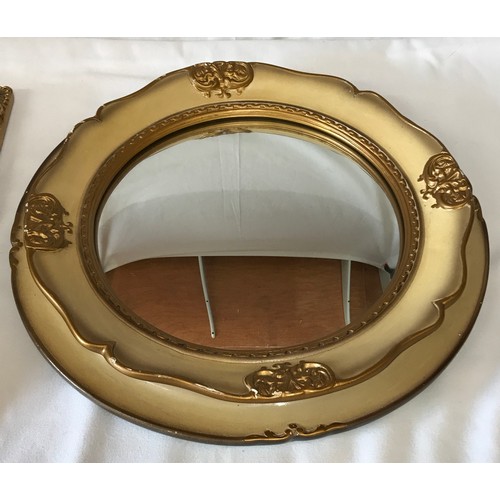 1133 - Two vintage mirrors one oblong 43 x 38cm with black and gilt trim and one round 44cm diameter