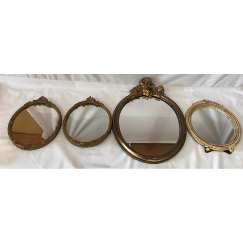 1134 - Four mirrors two matching gilt 33 x 23cm, one larger gilt 50 x 36cm with three cherubs at the top an... 