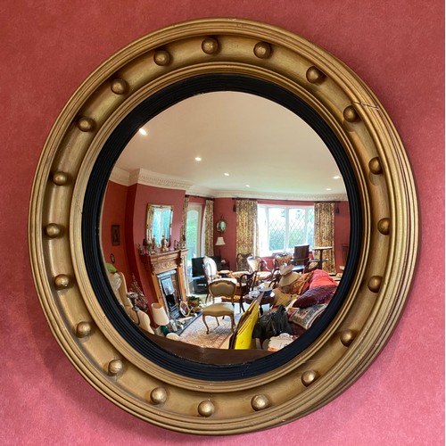 1136 - A large gilt convex wall mirror. 66cm d.