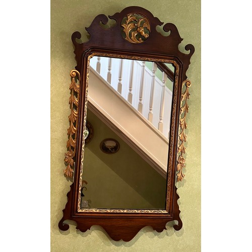 1140 - A mahogany fretted wall mirror with gilt decoration. 95 h x 51.5cm w.