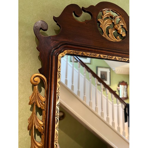 1140 - A mahogany fretted wall mirror with gilt decoration. 95 h x 51.5cm w.