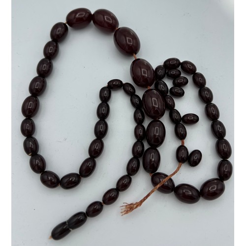 610 - Cherry amber bead necklace. Weight 64gm.