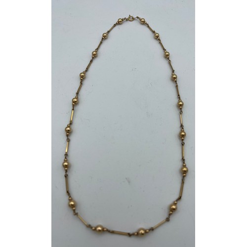 613 - A 9 carat gold chain and bead necklace, weight 9.9gm. Length  58cm.