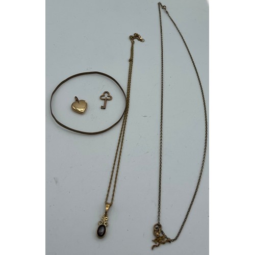 616 - Nine carat gold to include two pendants on chains, bangle and two charms, key unmarked. Total weight... 