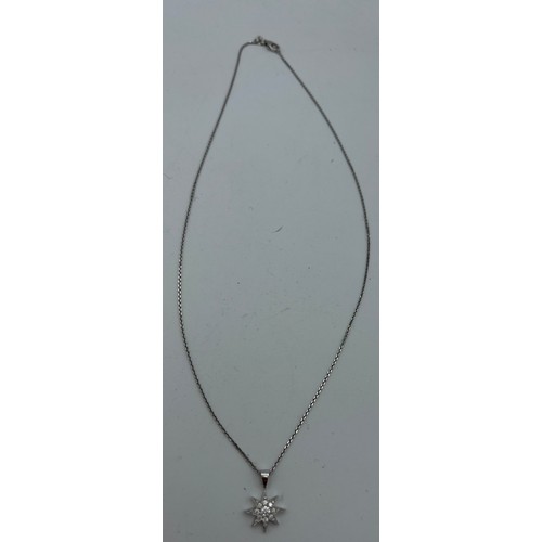 619 - An 18 carat white gold star pendant set with diamonds on fine chain 44cm length. Total weight 3.9gm.