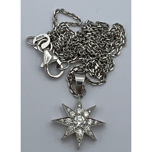 619 - An 18 carat white gold star pendant set with diamonds on fine chain 44cm length. Total weight 3.9gm.