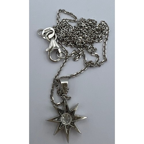 619 - An 18 carat white gold star pendant set with diamonds on fine chain 44cm length. Total weight 3.9gm.