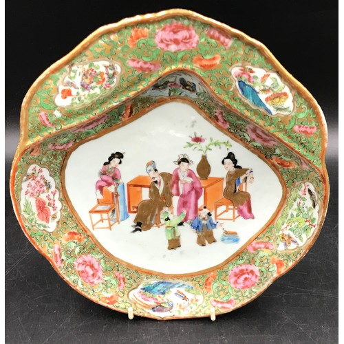 274 - An oriental plate depicting a family scene, unusual shape.