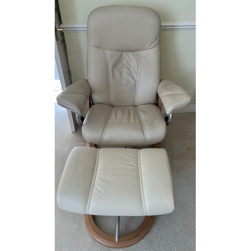 164 - Cream leather Stressless armchair and footstool.