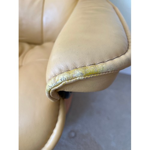 165 - Mustard coloured leather Stressless armchair and footstool.